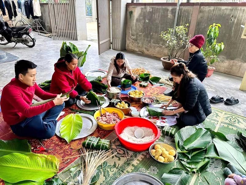 Gia đình sum họp gói bánh chưng đón Tết.